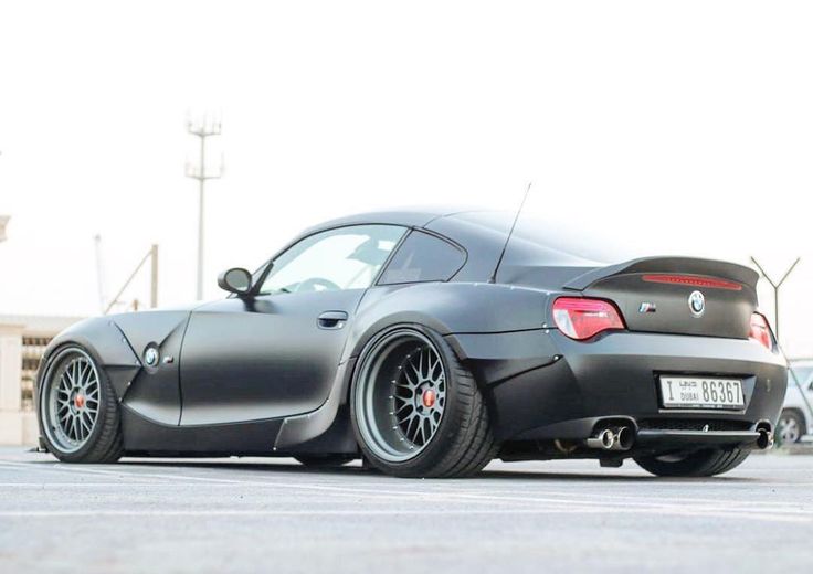 a black sports car parked in a parking lot