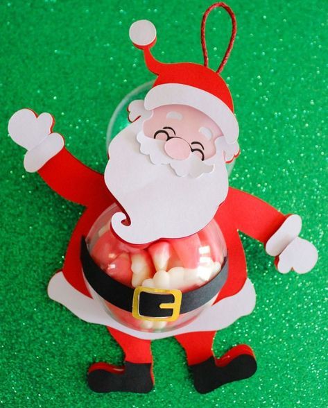 a santa clause ornament hanging on a green surface