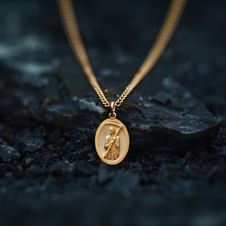 Experience the divine protection and guidance with our solid gold Santa muerte pendant. Expertly crafted in the USA, this exquisite piece honors the revered figure of Santa Muerte, celebrated for bestowing blessings and safekeeping. Made from premium solid gold, it showcases intricate detailing that brings the iconic imagery to life, making it a powerful symbol of faith and devotion. PENDANT INFORMATIONThis pendant is made of real, solid gold.• Made in USA• Material: 14k or 18k solid gold• Finish: polished• Height: 1.25" (31,5 mm) | *includes the small circle, bail dimensions not included• Width: 0.84" (21 mm)• Pendant weight: approx. 8 grams (14k)• Bail: fits up to 4 mm chains• Solid back, not hollow• A certificate of authenticity is included• Delivered in our elegant jewelry box, making Commemorative Medallion Amulet Jewelry, Ceremonial 14k Gold Medallion Jewelry, Spiritual Memorial Coin Pendant Jewelry, Memorial Spiritual Coin Pendant Jewelry, Commemorative Pendant Locket Jewelry, Spiritual Brass Jewelry For Commemoration, Spiritual 14k Gold Medallion Jewelry, Spiritual 14k Gold Locket Necklace, Symbolic Medallion Jewelry For Commemoration