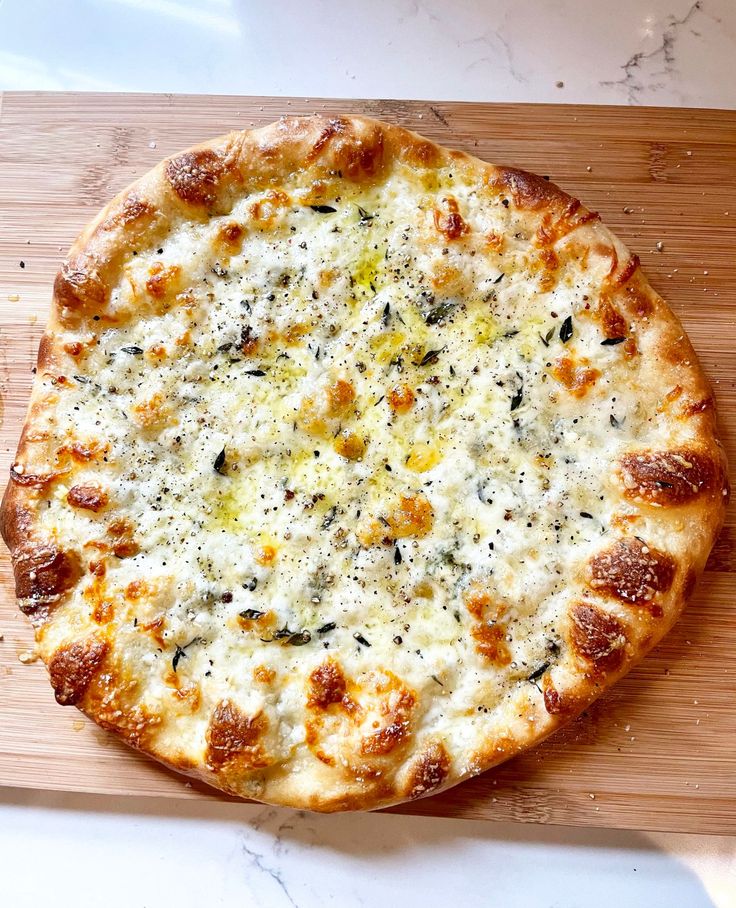 a pizza sitting on top of a wooden cutting board