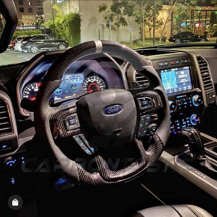 the interior of a car with steering wheel, dashboard and dash lights on display at an auto show