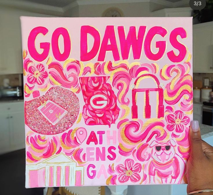 a person holding up a sign that says go dawgs at gen's garage