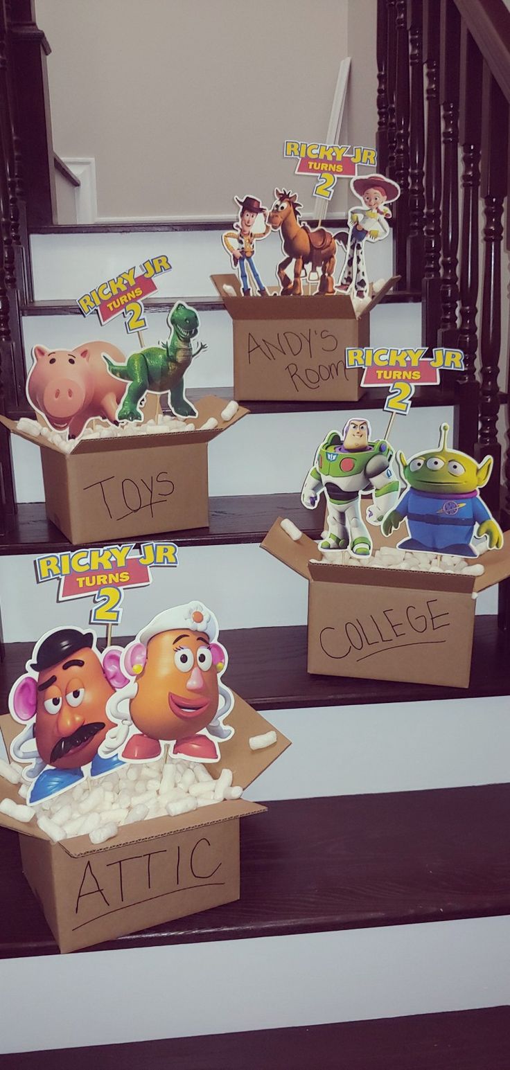 cardboard boxes with toy story characters on them sitting on the steps in front of some stairs