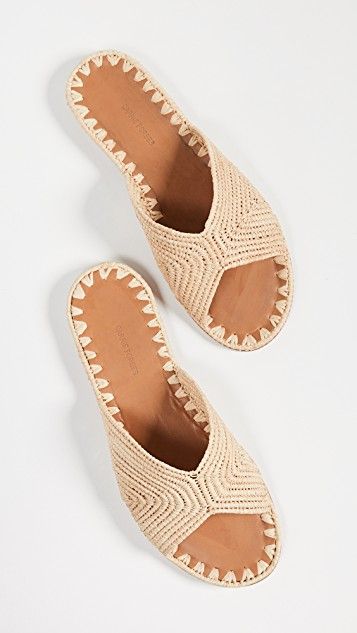 Carrie Forbes Salon Slides Summer Slip-on Mules With Leather Sole, Leather Sole Slip-on Mules For Vacation, Beige Straw Mules For Vacation, Beige Mules With Woven Sole For Vacation, Summer Slip-on Mules With Woven Sole, Summer Vacation Slippers With Open Heel, Summer Vacation Open Heel Slippers, Beige Flat Slides For Vacation, Beige Open Toe Slides With Rubber Sole