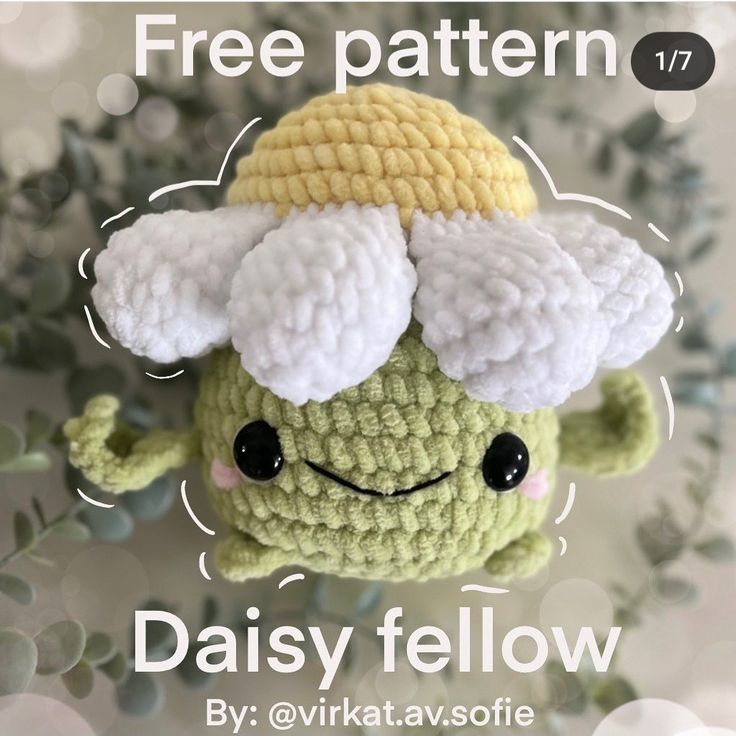 a crocheted amigurt with a hat on it's head and the text free pattern 17 daisy fellow