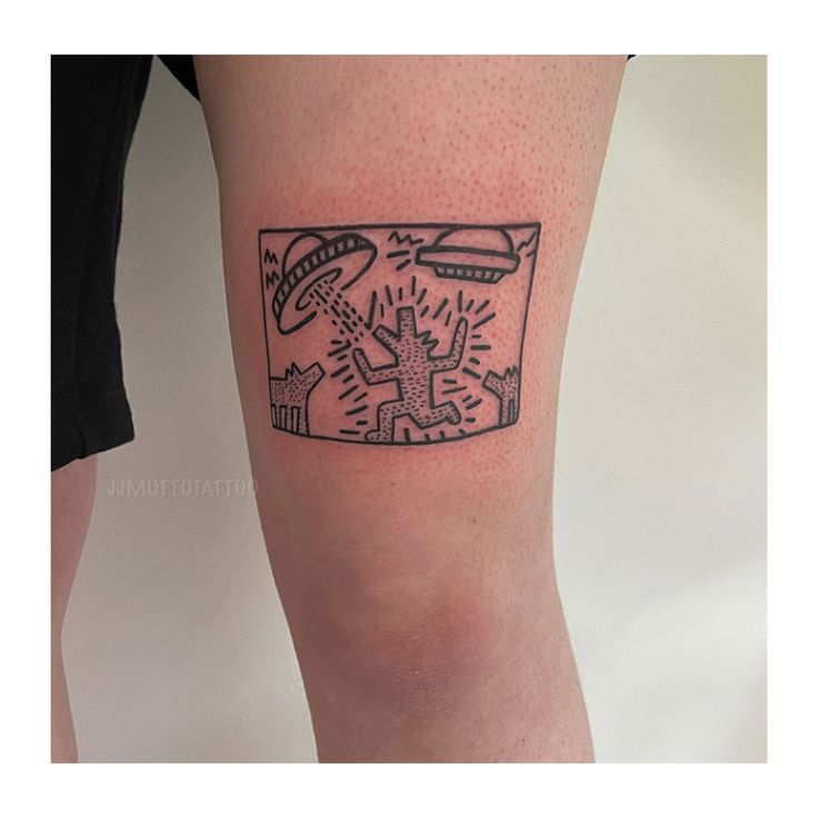 a person with a tattoo on their leg that has an image of a tv screen