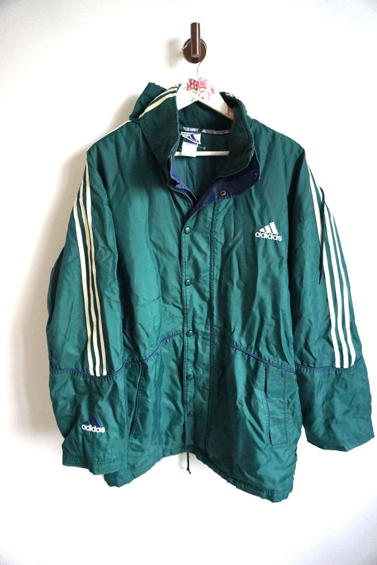 Jacket details: * Green ADIDAS windbreaker outwear jacket * Zipper and snap buttons on front * Two pockets * Condition: Perfect vintage condition, but zipper is broken, thats why price reduced.  Length: 37 " / 86cm Armpit to armpit: 28" / 68 cm sleeve: 25" / 62cm Label size: D-7 (L) Feel free to message me with any questions Adidas Track Jacket For Training, Adidas Sportswear Track Jacket For Training, Athleisure Nylon Track Jacket With Three Stripes Branding, Athleisure Nylon Track Jacket With Three Stripes, Nylon Athleisure Track Jacket With Three Stripes, Sporty Nylon Outerwear With Three Stripes, Sporty Nylon Outerwear With Stripes, Sporty Adidas Windbreaker For Winter, Sports Nylon Outerwear With Three Stripes Branding