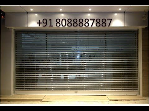 an empty room with some lights on the ceiling and blinds in the window behind it