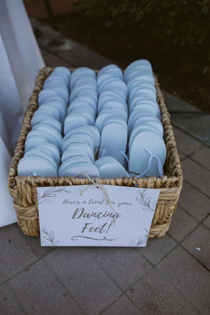 a basket filled with blue candles sitting on top of a brick floor next to a sign that says, there is a thank you dancing feel