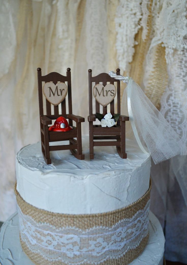 two wooden chairs sitting on top of a white cake