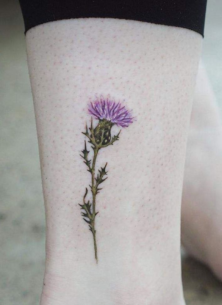 a small purple flower on the ankle