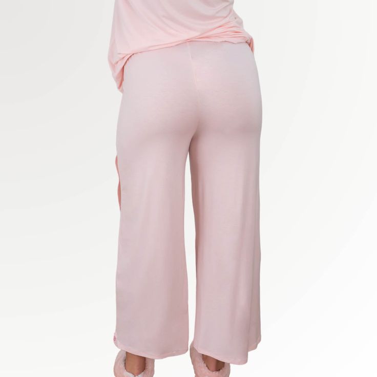 Faceplant Bamboo Tulip Pant The swish and sway of the crossover Tulip pants and shorts lends elegance to our coziest pajama bottoms ever. Elastic waistline for comfort and ease. Made from our signature Faceplant Bamboo blend, this collection inspires fluid movement. Dance. Play. Dream. In The Tulip you’ll look as good as you feel. Complete your look with the Tulip Tank Spring Yoga Pants For Loungewear, Comfortable Stretch Harem Pants For Loungewear, Versatile Yoga Pants For Spring Loungewear, Comfortable Solid Harem Pants For Loungewear, Spring Relaxation Comfortable Pants, Comfortable Spring Pants For Relaxation, Comfortable Pants For Relaxation And Spring, Casual Modal Wide Leg Bottoms, Casual Wide Leg Modal Bottoms