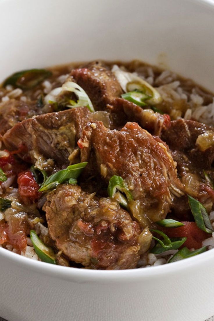 a white bowl filled with meat and rice