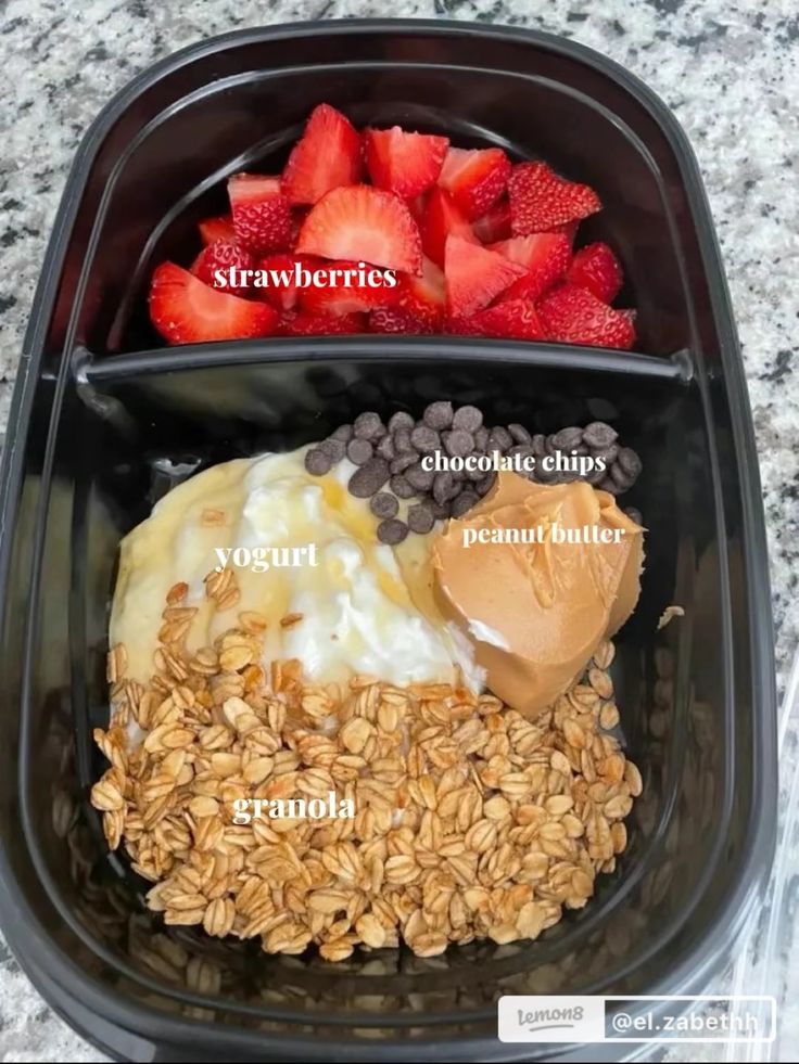 an image of food in a container with strawberries and yogurt