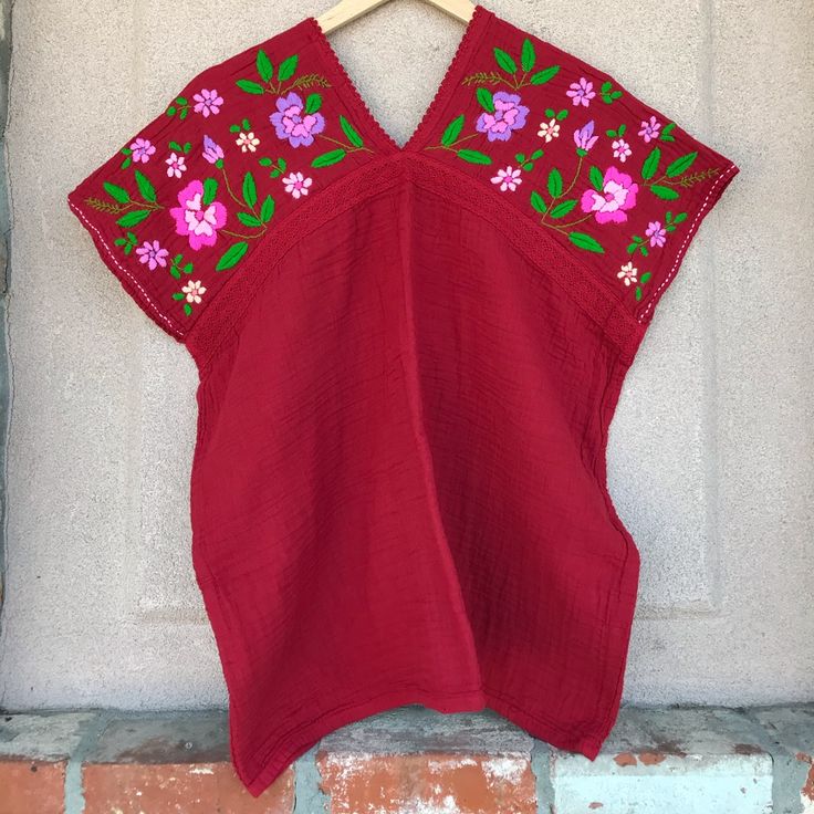 A Short Sleeve Top, Butterfly Shape With V Neck Front And Back, He Top Made Of Double Layer Cotton Designed With Lace Across The Chesr And Nice Hand Embroidered At Chest Up To The Sholder, There Are Many Colours. Color : Red Hand Embroidered Made In Thailand Red Folk Tops With Floral Embroidery, Red Bohemian Embroidered V-neck Top, Red V-neck Blouse With Floral Embroidery, Red Peasant Blouse For The Beach, Traditional Red Peasant Top With Floral Embroidery, Red Cotton Folk Top, Bohemian Red Embroidered V-neck Top, Red Bohemian V-neck Embroidered Top, Red Embroidered Folk Peasant Top