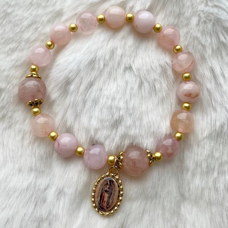 This is a handmade rosary bracelet adorned with Our Lady of Guadalupe medal. Cord used is stretchy. It includes 10 + 3 Hail Mary beads (8mm pink Quartz) and 2 slightly larger Our Father beads (10mm pink Quartz).   Each bracelet includes a storage pouch. Length: approximately 7-7.5 inches (small to medium adult wrist) Part of the earnings made from these rosaries will go towards funds for the discernment of our little ones' vocation. Please help us pray that they may choose a good and Holy one in Handmade Rosary, Virgin Of Guadalupe, Our Lady Of Guadalupe, Our Father, Pretty Beads, Rosary Bracelet, Lady Of Guadalupe, Hail Mary, Catholic Gifts