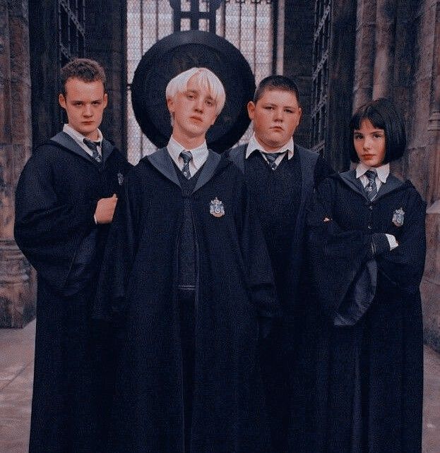 three harry potters standing in front of an iron gate