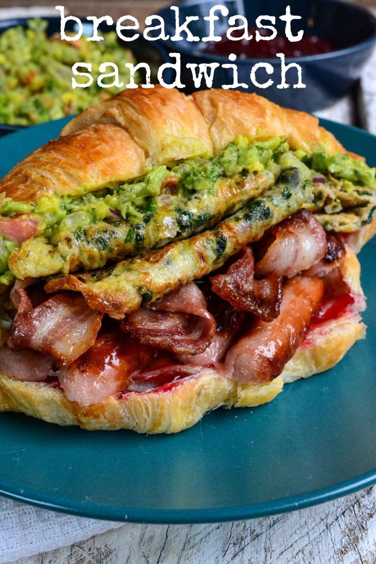 a sandwich with meat and guacamole on it sitting on a blue plate