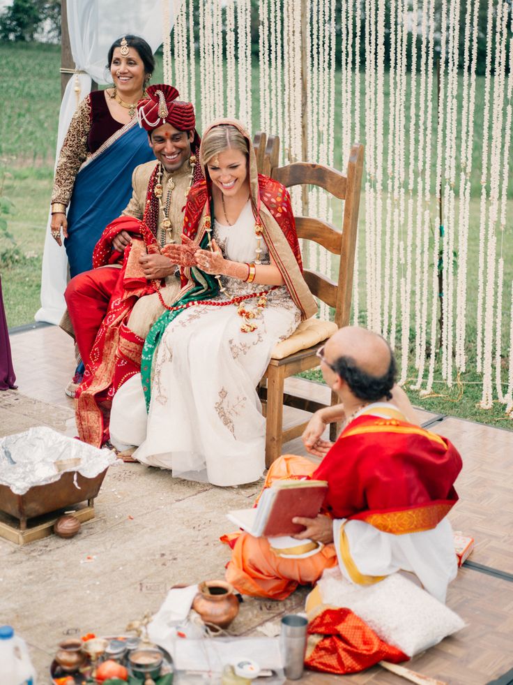 a group of people sitting on top of a wooden bench