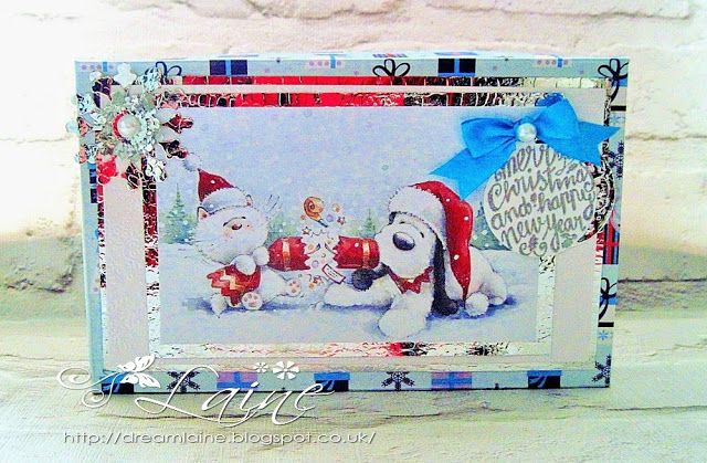 a christmas card with a dog and snowman in the background, on top of a table