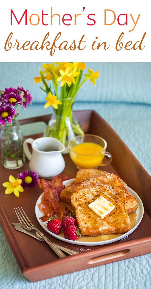 a breakfast tray with toast, fruit, and coffee on it is shown in this image