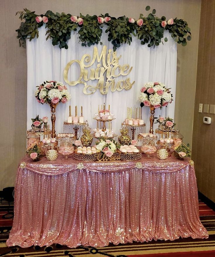 a table topped with lots of cakes and desserts next to a sign that says mr & mrs