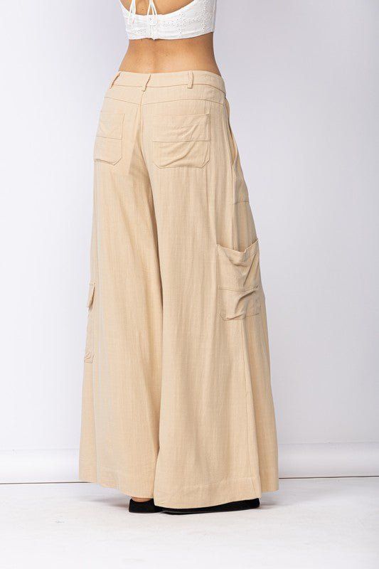 Final Sale - Get it before it's gone! Style the Cape May Beige Linen Wide-Leg Pants with your favorite summer top for a chic summer look! Linen blend fabric shapes these wide-leg pants with side cargo pockets and back patch pockets. DETAILS & CARE 70%Viscose, 30% Linen Machine Wash Cold. Imported. Wide Leg Cargo Pants For Spring, Full Length Wide Leg Pants With Pockets For Beach, Vacation Wide Leg Full Length Pants With Pockets, Baggy Wide-leg Bottoms With Patch Pockets, Baggy Wide Leg Bottoms With Patch Pockets, Summer Utility Style Wide Leg Pants, Versatile Summer Pants With Patch Pockets, Casual Linen Pants With Multiple Pockets, Summer Full-length Wide Leg Cargo Pants