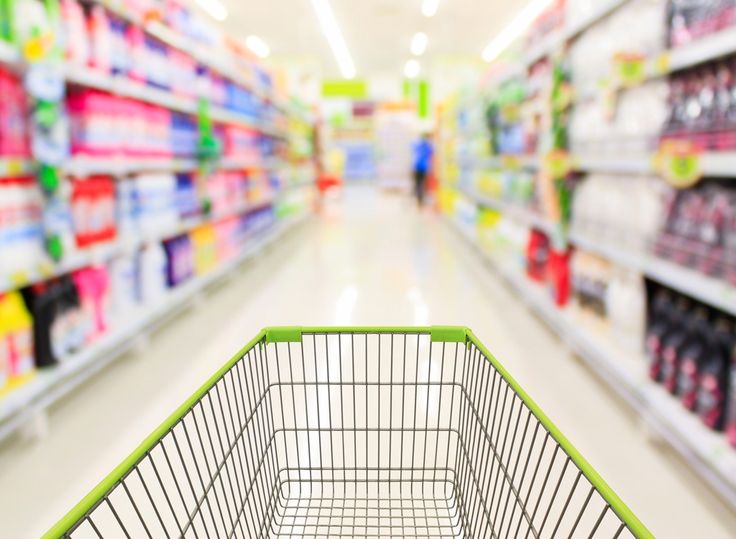 a shopping cart in a grocery store aisle