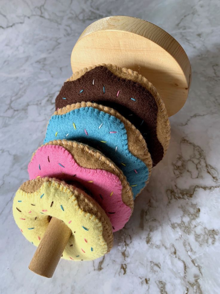 a wooden toy with doughnuts and sprinkles on it's sides