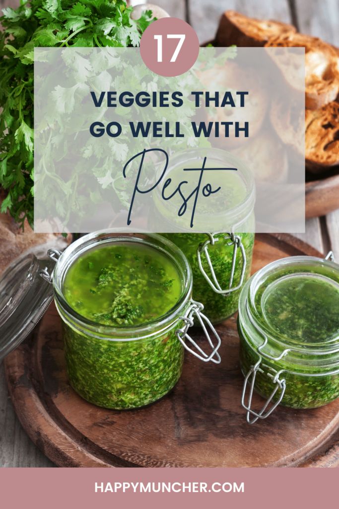 two jars filled with pesto on top of a wooden cutting board next to bread