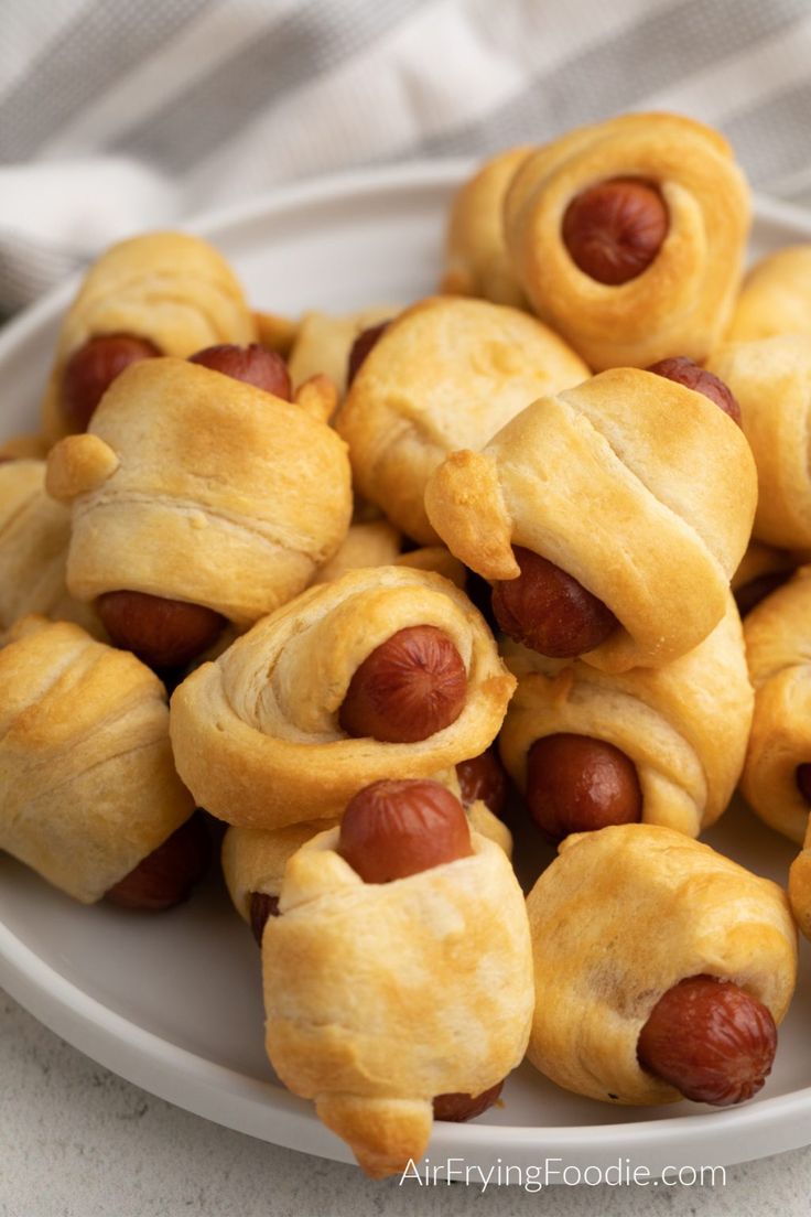 a white plate topped with pigs in a blanket