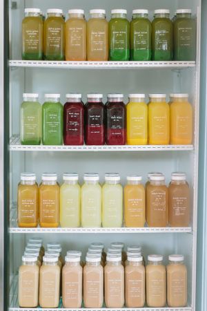 many different types of juices are on shelves