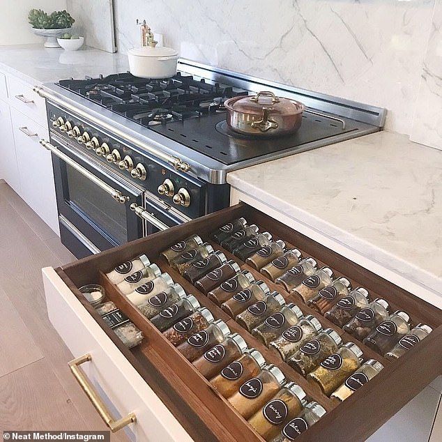 an open drawer in the middle of a kitchen next to a stove and counter top