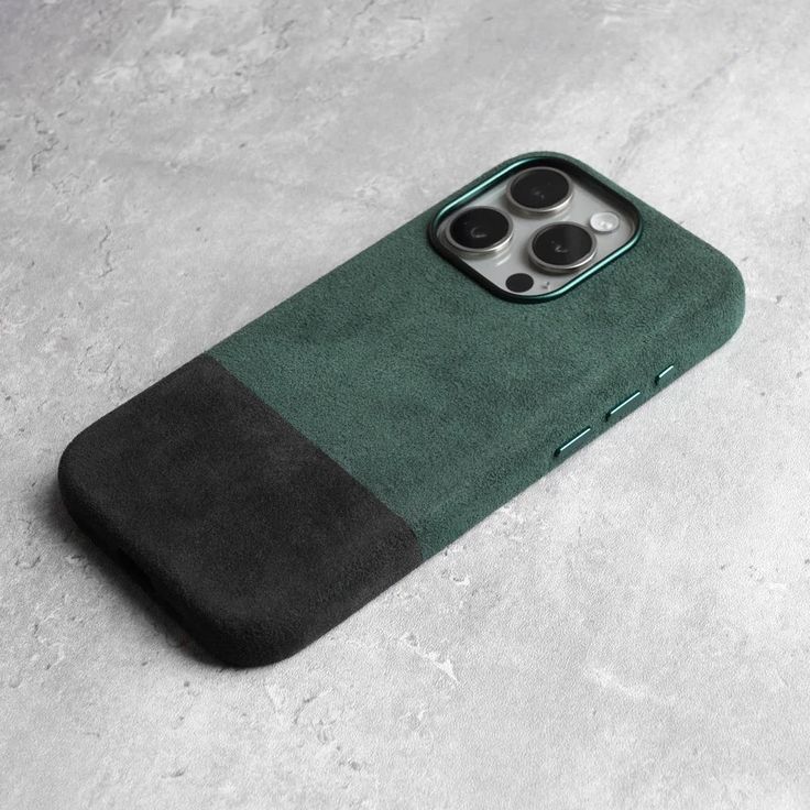 an iphone case with two buttons on the back and one button in the middle, sitting on a concrete surface