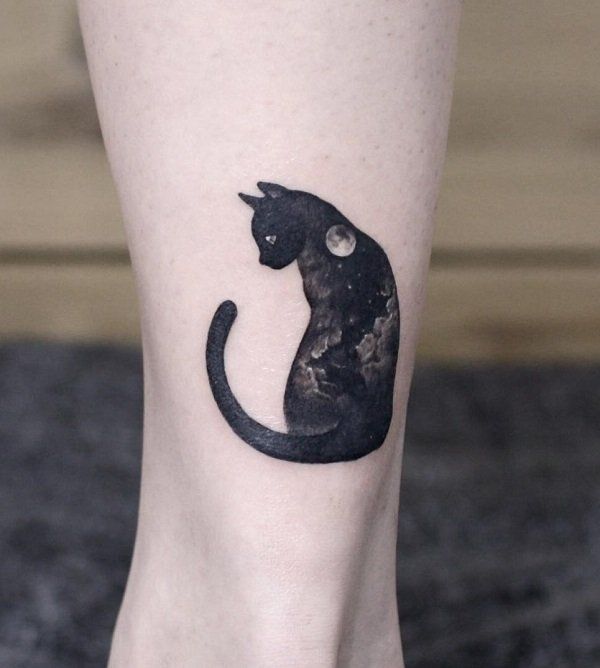 a black cat tattoo on the right leg and foot, with space in the background