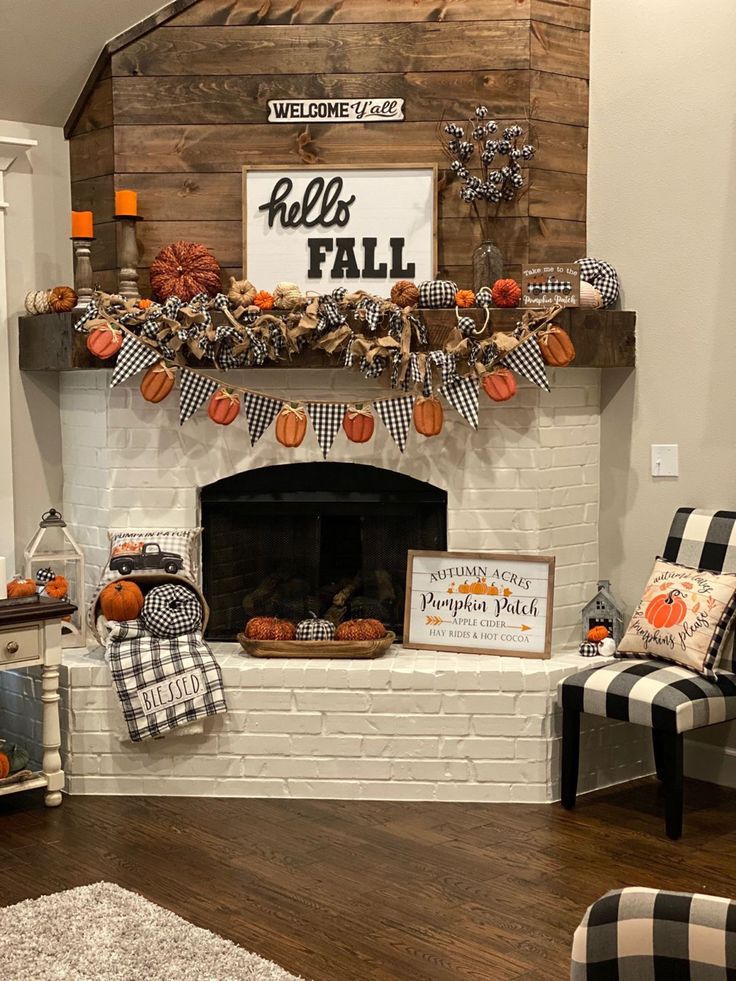 a fireplace decorated for fall with pumpkins and decorations