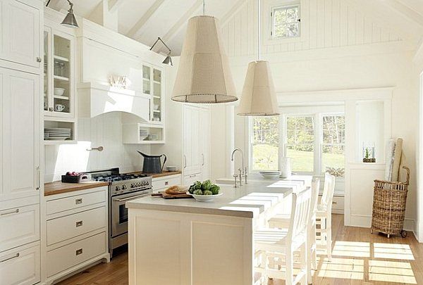 a kitchen with white cabinets and an island in the middle, along with lots of counter space