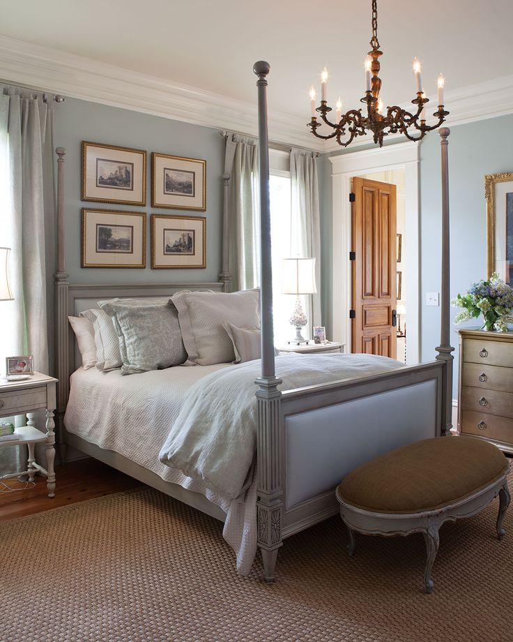 a bedroom with a canopy bed and chandelier