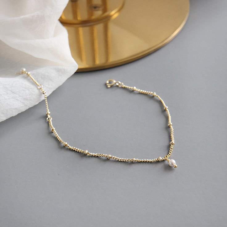 Take this freshwater pearl bracelet out for a spin on a 18k gold vermeil chain that goes with everything. Material : 18k Gold Over 925 Sterling Silver Length : 7" Natural Freshwater Pearl Dainty Pearl Drop Jewelry, Dainty Pearl Drop Bracelet, Dainty Gold Bracelets With Pearl Chain, Dainty Gold Pearl Bracelet With Pearl Charm, Dainty Pearl Bracelet With Pendant As Gift, Gold Plated Pearl Drop Bracelet, Dainty 14k Gold-filled Pearl Bracelet, Delicate Gold Bracelets With Pearl Charm, Gold Bracelet With Pearl Pendant As Gift