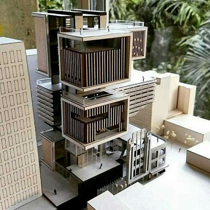 a model of a building in the middle of a city with tall buildings and palm trees