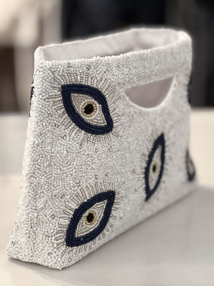 an eye pouch is sitting on a table with the eyes painted on it's side