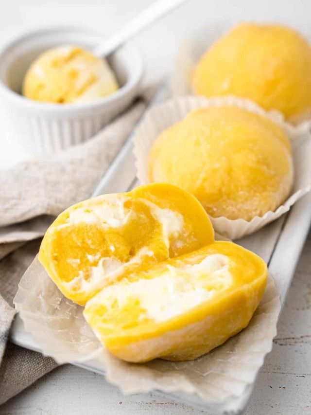 two peeled lemons sitting on top of paper