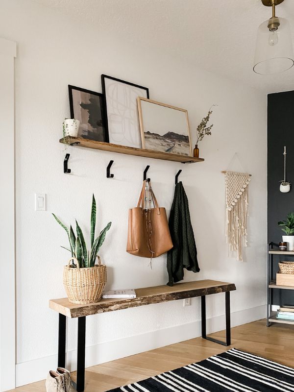 a room with some plants and pictures on the wall