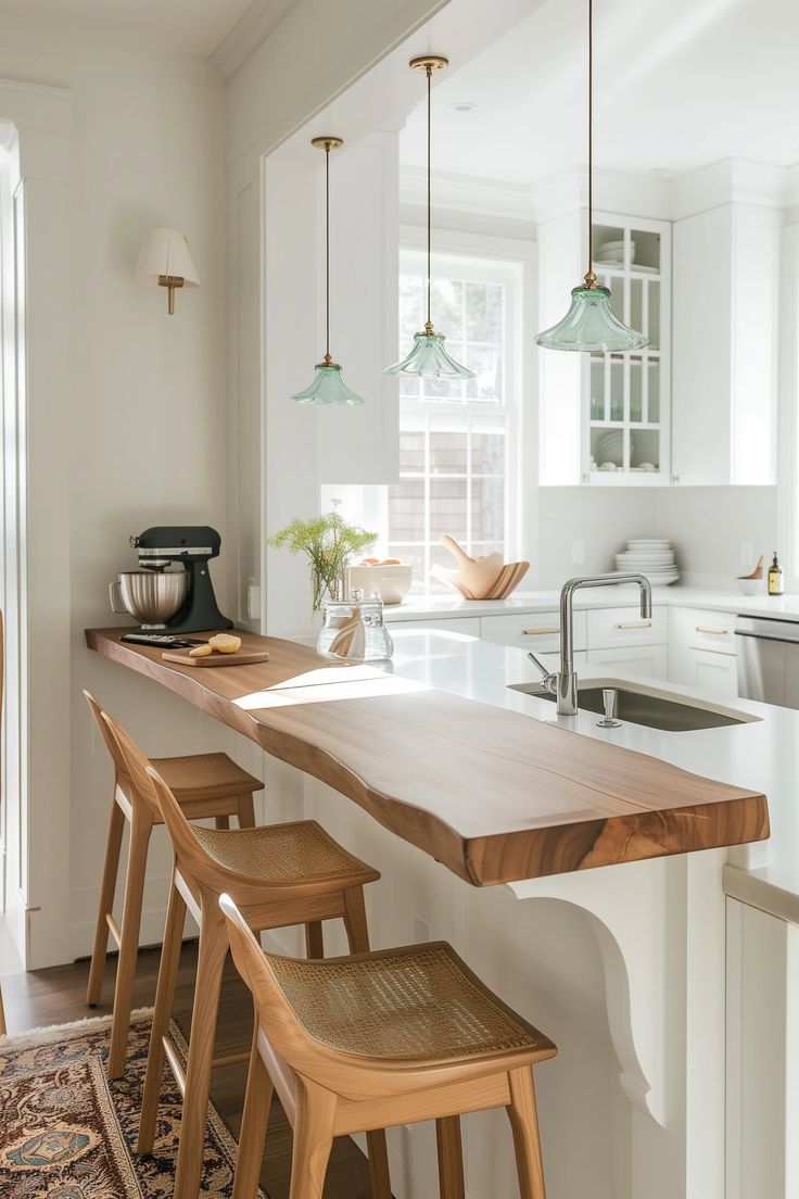 a kitchen with an island and stools in front of the counter top that is made out of wood