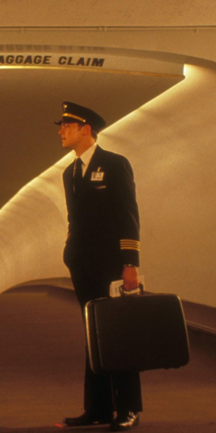 a man in an air force uniform holding a suitcase