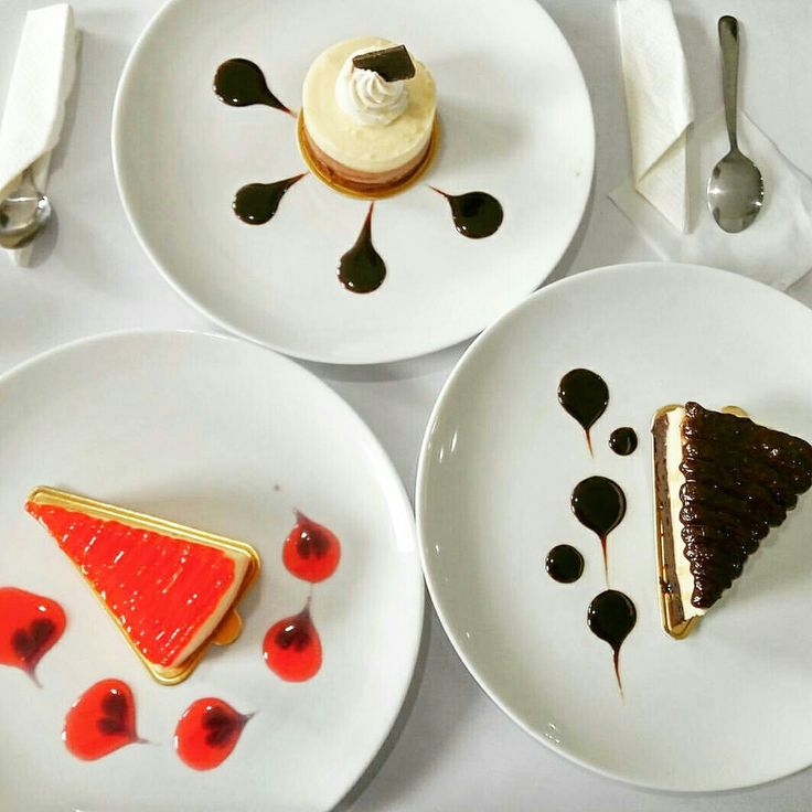 three white plates topped with desserts on top of a table next to utensils