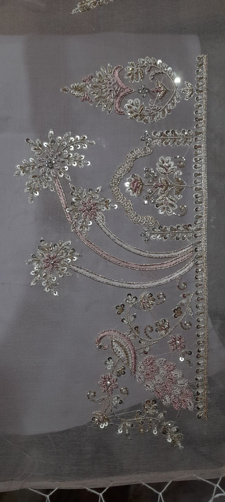 a piece of cloth with beading on it