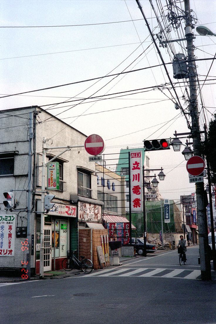 an intersection with traffic lights, signs and buildings