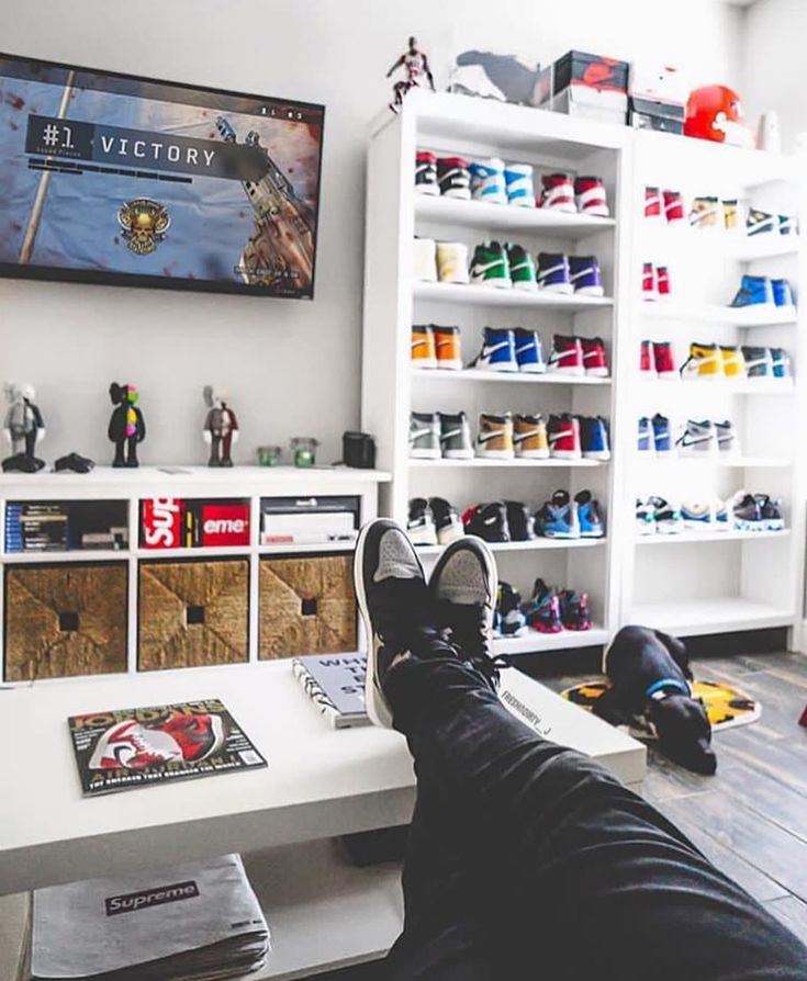 a person's feet resting on a desk in front of a television