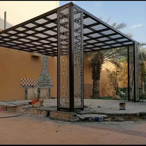 an outdoor gazebo in the middle of a courtyard with tiled floors and walls, surrounded by palm trees